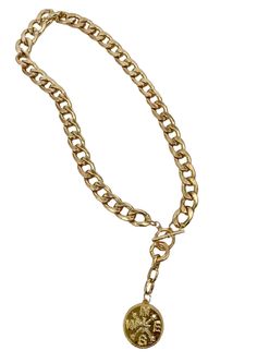 This snake chain necklace commands attention with its bold design and luxurious appeal. Crafted from gleaming gold, each link in the chain is substantial, exuding a sense of opulence and strength. At its center lies the focal point of the piece: a large gold charm shaped like a compass rose, with distinct north, south, east, and west directions. The charm is intricately detailed, its smooth surface catching the light and casting a warm, radiant glow. Completing the necklace is a gold toggle clasp, adding both functionality and style to the piece. The total length is 20 inches with the clasp right at 18 inches. When worn, this statement necklace becomes more than just an accessory; it becomes a symbol of confidence, sophistication, and timeless elegance. Its weight on the neckline serves as Metal Charm Necklace With Adjustable Snake Chain, Chic Toggle Link Necklace With Chain, Trendy Gold Plated Snake Chain Necklace, Metal Snake Chain Charm Necklace, Gold Metal Snake Chain Jewelry, Yellow Gold Metal Chain Necklace With Curb Chain, Trendy Gold-plated Pendant Chain Necklace, Trendy Gold Snake Chain Jewelry, Gold Plated Jewelry With Chain Strap For Gift