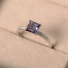 This ring features a 6*6mm princess cut lab alexandrite and sterling silver finished with rhodium. Customization is available. It is made by hand, and it will take about 7 days to finish the ring after your payment is completed. Any question, just let me know. :) My shop homepage: https://www.etsy.com/shop/LuoJewelry?ref=l2-shopheader-name Engagement Ring Princess Cut, Engagement Ring Princess, Ring Princess Cut, Original Engagement Rings, Alexandrite Engagement Ring, Alexandrite Ring, Topaz Engagement Ring, Princess Cut Engagement Rings, June Birthstone