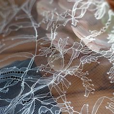 the lace is white and has flowers on it