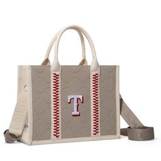 Officially Licensed Major League Baseball Merchandise Made of synthetic leather Embossed T logo on the front All-over embossed T logo pattern Red stitching detail Top zipper closure A zip pocket and a snap-button closure on the back pocket Adjustable and detachable crossbody strap(Drop: 17"-28.8") 12.8"(L) x 4.8"(W) x 9.5"(H) Interior Capacity: Large Beige Shoulder Bag With Embroidered Logo And Double Handle, Beige Shoulder Bag With Embroidered Logo For Everyday Use, Brown Rectangular Bag With Embroidered Logo, Brown Travel Bag With Embroidered Logo, Trendy Embroidered Logo Tote Shoulder Bag, Brown Leather Bags With Embroidered Logo, Brown Bag With Embroidered Logo For Everyday Use, Trendy Bags With Embroidered Logo For Daily Use, Trendy Shoulder Bag With Embroidered Logo For Travel