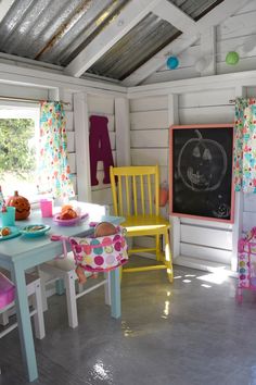 a child's room with colorful chairs and a chalkboard