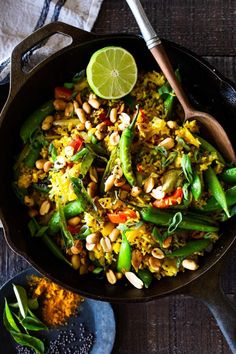 a skillet filled with rice, beans and vegetables