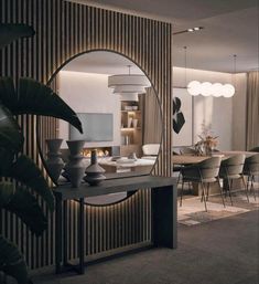 a living room with a large mirror on the wall next to a table and chairs