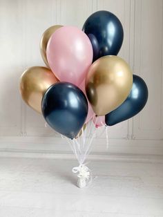 a bunch of balloons that are in the shape of a heart on a white table