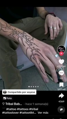 a person with tattoos on their arm and hand