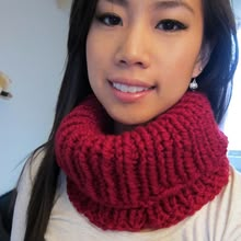 a woman wearing a red knitted cowl