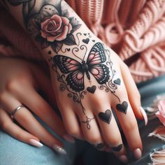 a woman's hand with tattoos and roses on it