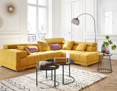 a living room with yellow couches and coffee table