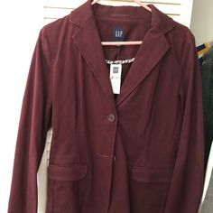 This Is A Women’s Blazer From The Gap. Brand New With Tags. It Is A Wine/Maroon Color With Two Buttons In Front And Two Side Pockets. There Is A Cool White And Blue Patterned Lining Inside On The Pockets And Interior Seams. Professional And Chic Look! Casual Red Outerwear For Business Casual, Red Casual Blazer For Business Casual, Red Cotton Blazer For Work, Red Cotton Workwear Blazer, Casual Red Button-up Blazer, Classic Long-sleeved Burgundy Blazer, Red Cotton Button-up Outerwear, Red V-neck Cotton Outerwear, Dark Blue Blazer