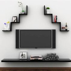 a flat screen tv sitting on top of a black shelf