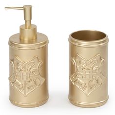 two gold bathroom accessories on a white background