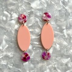 Turn heads and turn up the chic with our elongated oval drop earrings! Featuring an oval centerpiece in salmon pink flanked by two magenta and white hand-swirled acrylic mini circles. ▪️Length: 3”, Width: 0.75” ▪️Materials: acrylic, brass base posts/jump rings with 18k gold plating ▪️Hypoallergenic ▪️All earrings come with specialized backs to maintain the integrity of the product. As with all fused materials please be mindful of your use of force. Handle with care. Small variations can happen i Minimalist Closet, Elongated Oval, Lover Girl, Girl Closet, White Hand, Closet Designs, Salmon Pink, Pittsburgh Pa, Turn Up