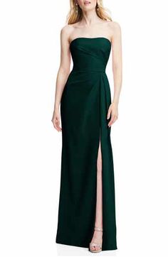 a woman in a long green dress with a slit down the side and one leg