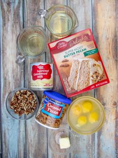 ingredients to make cake sitting on top of a wooden table