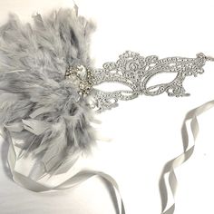 Pictured is a Silver lace mask with silver grey feathers to match and crystal brooch. Other styles are also available. S H I P P I N G - Processed same day or within 24 hours. 1-2 day guaranteed delivery services offered, add items to cart and click on shipping tab for rates. Pls leave a check out note with your need date & contact number (especially for expedited and custom orders) Msg for delivery time frames (Include your state/country). I N C L U D E D Mask comes with matching ribbons. S Silver Masquerade Mask, Masquerade Mask Women, Elegant Face Mask, Grey Feathers, Masquerade Ball Masks, Couples Masquerade Masks, Metal Mask, Lace Mask, Silver Lace