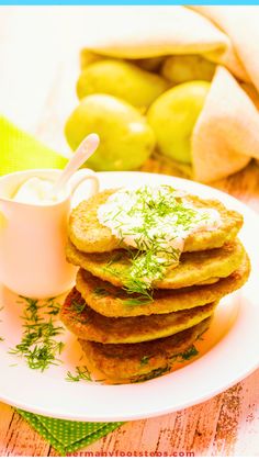 a stack of pancakes sitting on top of a white plate next to a bowl of yogurt