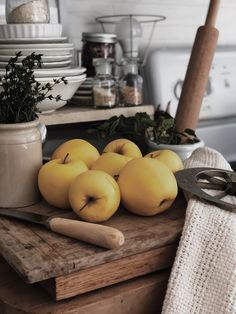 some apples are sitting on a cutting board