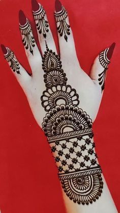 the hand is decorated with henna designs on it