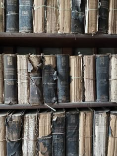 many old books are stacked on the shelves