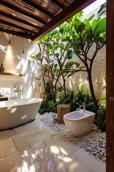 a bathroom with a tub, sink and trees in it