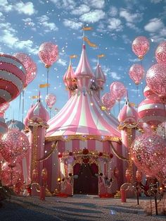 a pink and white circus tent surrounded by balloons