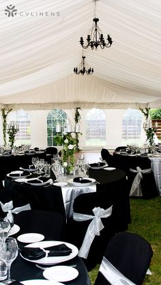 tables and chairs are set up in a tented area for an event or function