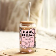 a jar with a straw in it sitting on top of a wooden tray next to a bed