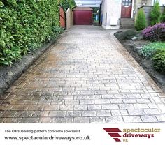 a brick walkway leading up to a garage