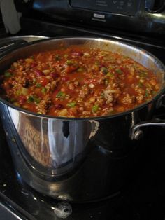 a large metal pot filled with food on top of a stove