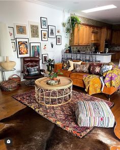 a living room filled with furniture and pictures on the wall