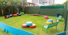 an outdoor play area with colorful chairs and tables