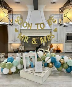 balloons and decorations are on display in the kitchen area for an anniversary party or bridal celebration