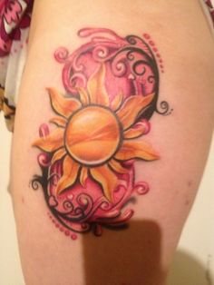 a woman's thigh with a sun tattoo on it