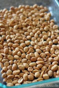 a glass dish filled with nuts sitting on top of a table