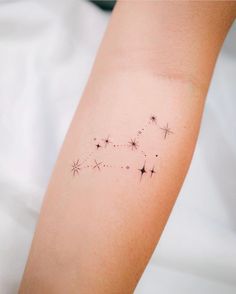 a woman's arm with a star tattoo on it