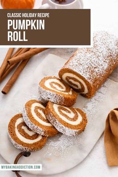 pumpkin roll on a white plate with cinnamon sticks next to it and the words classic holiday recipe pumpkin roll