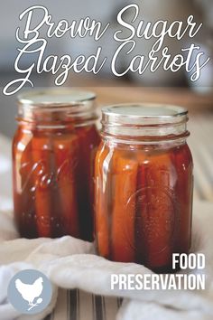 two mason jars filled with brown sugar and garnished carrots on top of a table