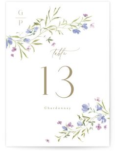 a table number card with purple flowers and greenery on the front, white background