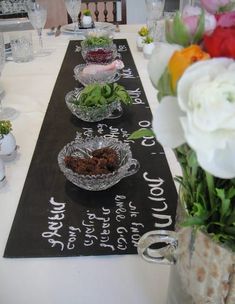 the table is set with flowers and dishes