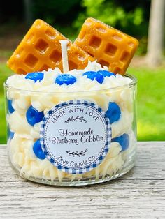 two waffles are sitting on top of some blueberry cobbles in a glass container