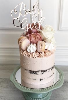 a baby girl cake decorated with shells and flowers