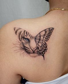 a woman's back with a tiger and butterfly tattoo on her left shoulder,