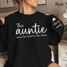 a woman wearing an black sweater that says, this annie was her heart on her sleeve