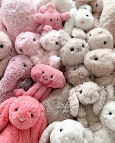 a pile of pink and white stuffed animals