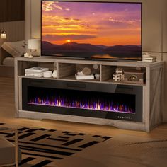 a living room with a large television on the wall and a fire place in front of it