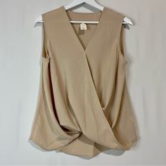 Women’s Sleeveless Faux Wrap V Neck Blouse Tan Size Large New Without Tags Approximate Hanging Measurements Shown In Photos 95% Polyester 5% Spandex Business Casual Summer Sleeveless Girly V Neck *Size Small Sold Versatile Sleeveless Office Vest, Versatile Sleeveless Vest For Office, Beige Tank Top For Work, Beige Vest For Work, Versatile Tank Vest For Workwear, Beige Sleeveless Blouse Tank Top For Workwear, Beige V-neck Tank Top For Work, Sleeveless Beige Workwear Blouse, Sleeveless Beige Blouse For Work