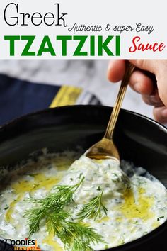 a person holding a spoon full of greek tzatzki sauce in a black bowl