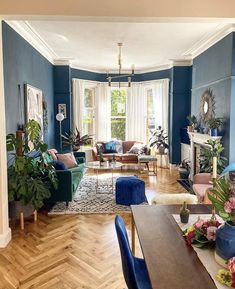 a living room with blue walls and wooden floors