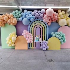 an entrance decorated with balloons and pastel colors