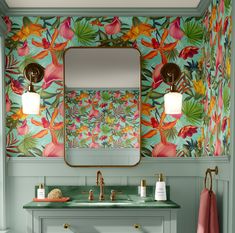 a bathroom with floral wallpaper and green counter top, gold faucet sink